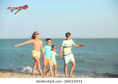 Happy Family Flying Kite On Sea Beach At Resort