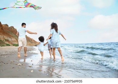 Happy Family Flying Kite On Sea Beach