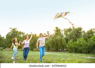 Happy Family Flying Kite Outdoors