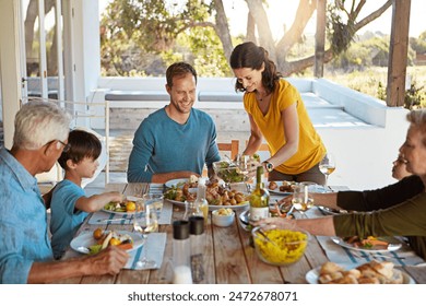 Happy family, food and lunch outdoor or meal on patio with conversation, bonding and healthy eating in summer. People, dinner and relax at dining table in backyard of home with supper and talking - Powered by Shutterstock