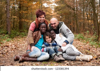 Happy Family With Foster Children In The Forest