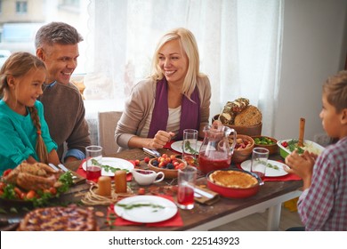 Happy Family Of Four Celebrating Thanksgiving Day