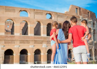 Happy Family Of Four Enjoy Italian Vacation On Colosseum Background. Italian European Family Vacation In Rome