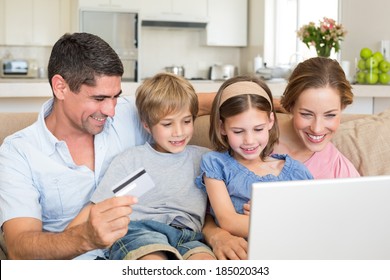 Happy Family Of Four Shopping Online In House