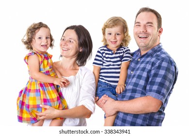 Happy Family Of Four Smiling While Standing Against White Background.