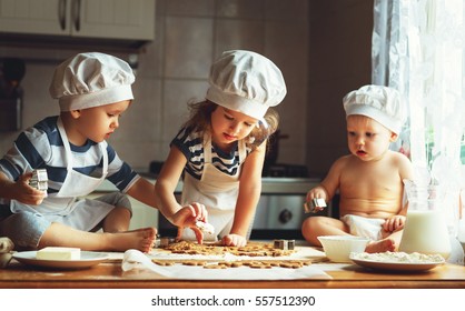 happy family  funny kids are preparing the dough, bake cookies in the kitchen