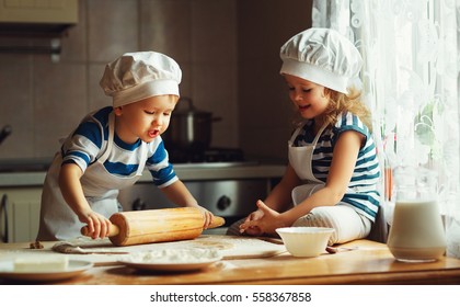 happy family  funny kids are preparing the dough, bake cookies in the kitchen