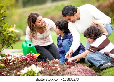 Happy Family Gardening Together And Taking Care Of Nature