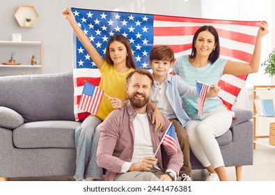 Happy family gathers on the sofa at home, adorned with USA flags, celebrating Independence Day with patriotic pride. With the joy of American citizens commemorating this special national day together. - Powered by Shutterstock