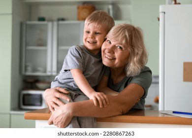 Happy family - grand mother hugs with grandson at home - Powered by Shutterstock