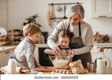 happy family grandmother and grandchildren cook in the kitchen, knead dough and bake cookies
 - Powered by Shutterstock