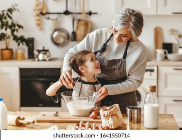 happy family grandmother and granddaughter child  cook in the kitchen, knead dough and bake cookies - Shutterstock ID 1641550714