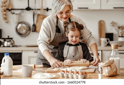 happy family grandmother and granddaughter child  cook in the kitchen, knead dough and bake cookies
 - Powered by Shutterstock