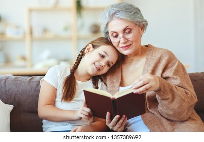 Happy Family Grandmother Reading To Granddaughter   Child Book At Home   
