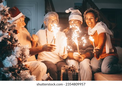 Happy family group of senior parents and middle aged son with wife celebrating Christmas holidays and new year together at home. Happy lifestyle for mature retirees, party lights