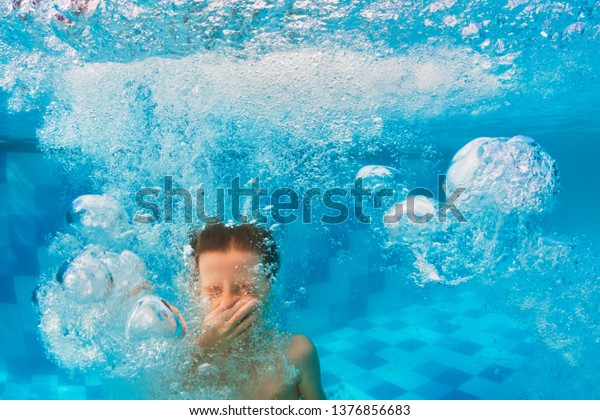 Happy family have fun in swimming pool. Funny child\
swim, dive in pool - jump deep down underwater from poolside.\
Healthy lifestyle, people water sport activity, swimming lessons on\
holidays with kids