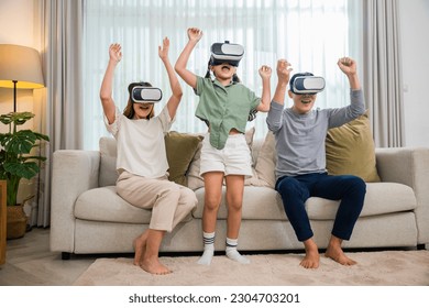 Happy family have mother father and daughter watching movie or playing video game, game entertainment innovation technology, Asian family wear vr glasses headsets excited sitting sofa in living room - Powered by Shutterstock
