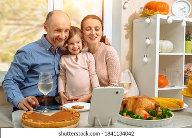 A happy family have a thanksgiving dinner and sends a video greeting to their parents by internet. - Powered by Shutterstock