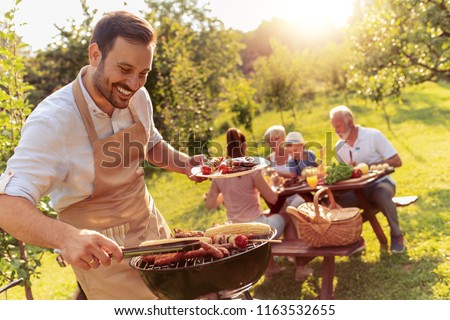 Happy family having barbecue party in backyard.Food,family,fun and happiness concept.