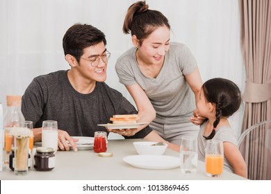 Happy Family Having Breakfast At Home