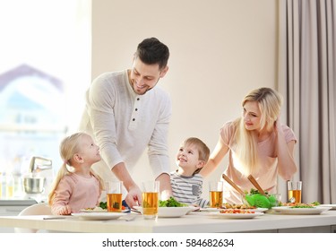 Happy Family Having Breakfast At Home