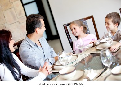 Happy Family Having Dinner In The Dinning Room