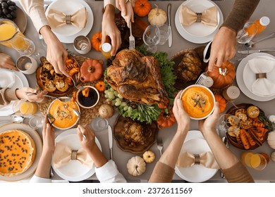 Happy family having dinner at festive table on Thanksgiving Day, top view