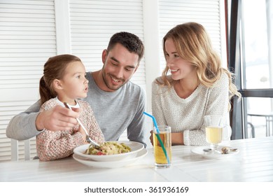 Happy Family Having Dinner At Restaurant Or Cafe