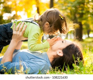 Happy Family Having Fun In Autumn Park