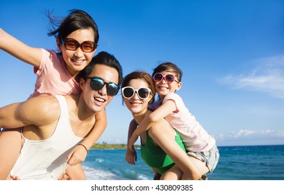 Happy Family Having Fun at the Beach