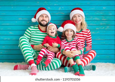 Happy Family Having Fun At Christmas Time. Father, Mother And Children At Home. Xmas Holiday Concept