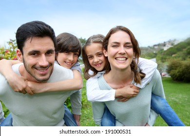 Happy Family Having Fun In Home Garden