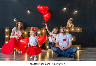 Happy Family Having Fun On Saint Valentine's Day. Parents With Little Kids With Heart Baloons. Family Portrait