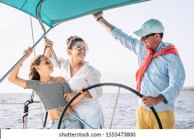 Happy Family Having Fun On Sailboat Vacation - Mother Father And Daughter Enjoying Time Together Doing Luxury Boat Trip - Travel Adventures And Love People Concept 