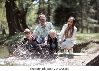 Happy Family Having Fun On The Lake.