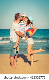 Happy Family Having Fun On The Beach. Summer Vacation And Travel Concept