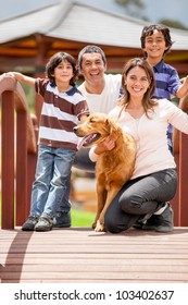 Happy Family Having Fun Outdoors With Their Dog