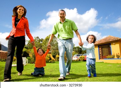 Happy Family Having Fun Outdoors At Home On A Sunny Day