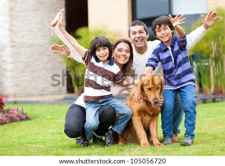 Happy family having fun outside their house