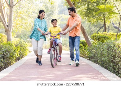 Happy family having fun at park - Shutterstock ID 2239538771