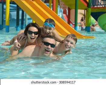 Happy Family Having Fun In A Pool