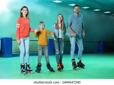 Happy Family Having Fun At Roller Skating Rink