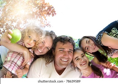 Happy Family Having Fun In Summer Park