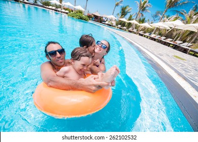 Happy Family Having Fun In The Swimming Pool