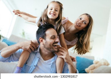 Happy family having fun time at home - Shutterstock ID 1302981817