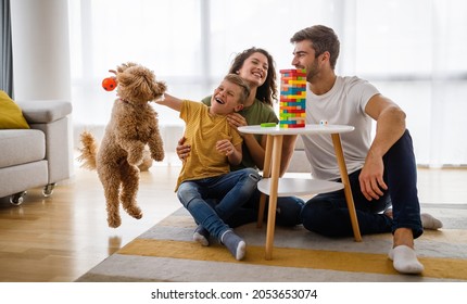 Happy Family Having Fun Time, Playing Together At Home With Dog