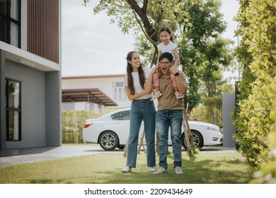 Happy Family Having Fun Time At Home. Asian Family With Little Kids Daughter Playing Together In House Backyard Outside. Happy Family Time.