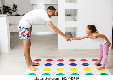 Happy Family Having Fun Together, Playing Twister Game At Home