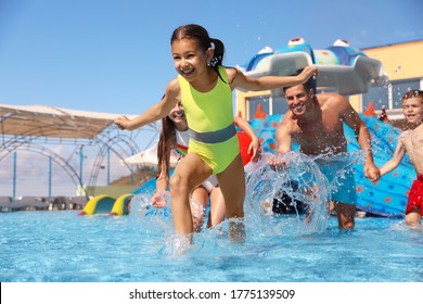 Happy Family Having Fun At Water Park. Summer Vacation