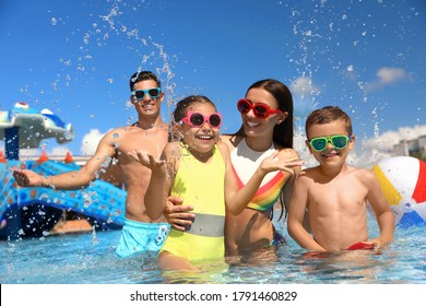 Happy Family Having Fun At Water Park. Summer Vacation